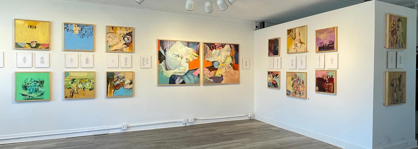 Photograph of gallery walls with paintings and mounted poems
